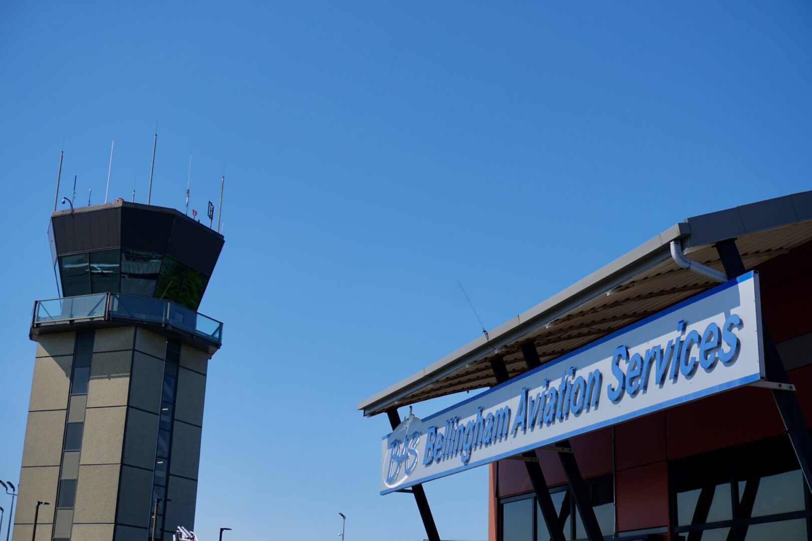 Control tower and aviation services sign.