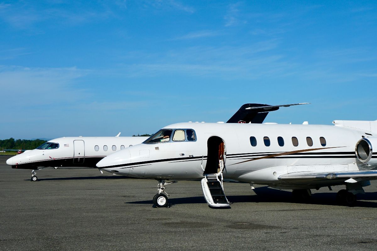 Two private jets parked on airport tarmac