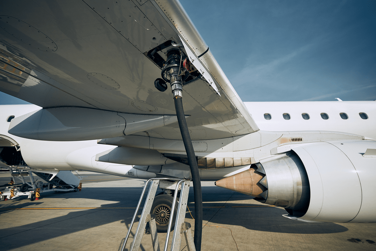 Airplane refueling on airport tarmac.