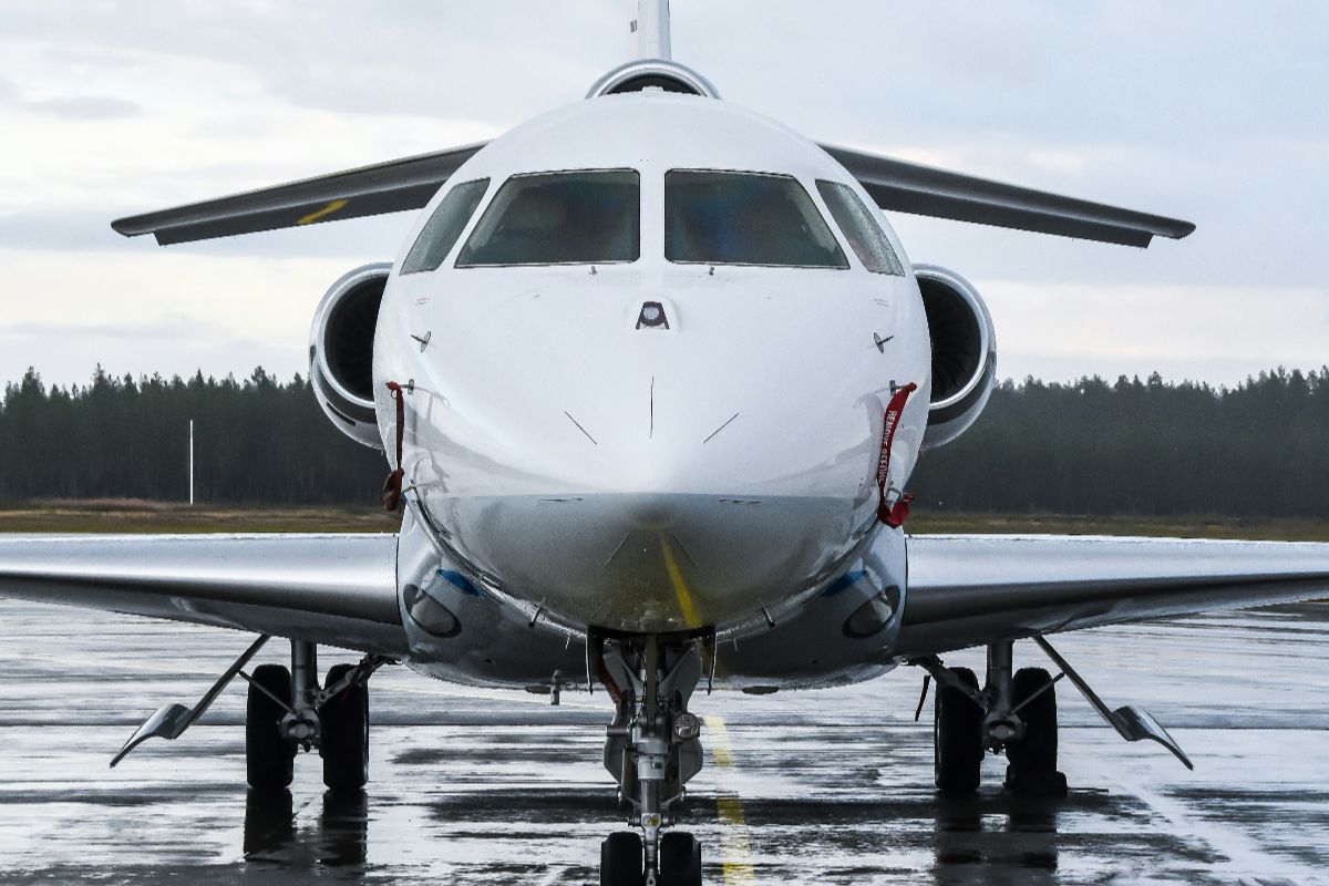 Front view of private jet on wet runway