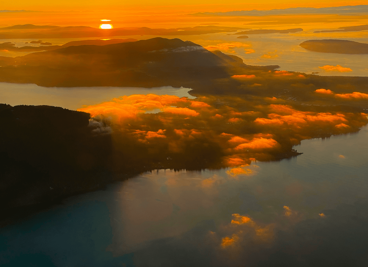 Sunset over islands with glowing clouds.