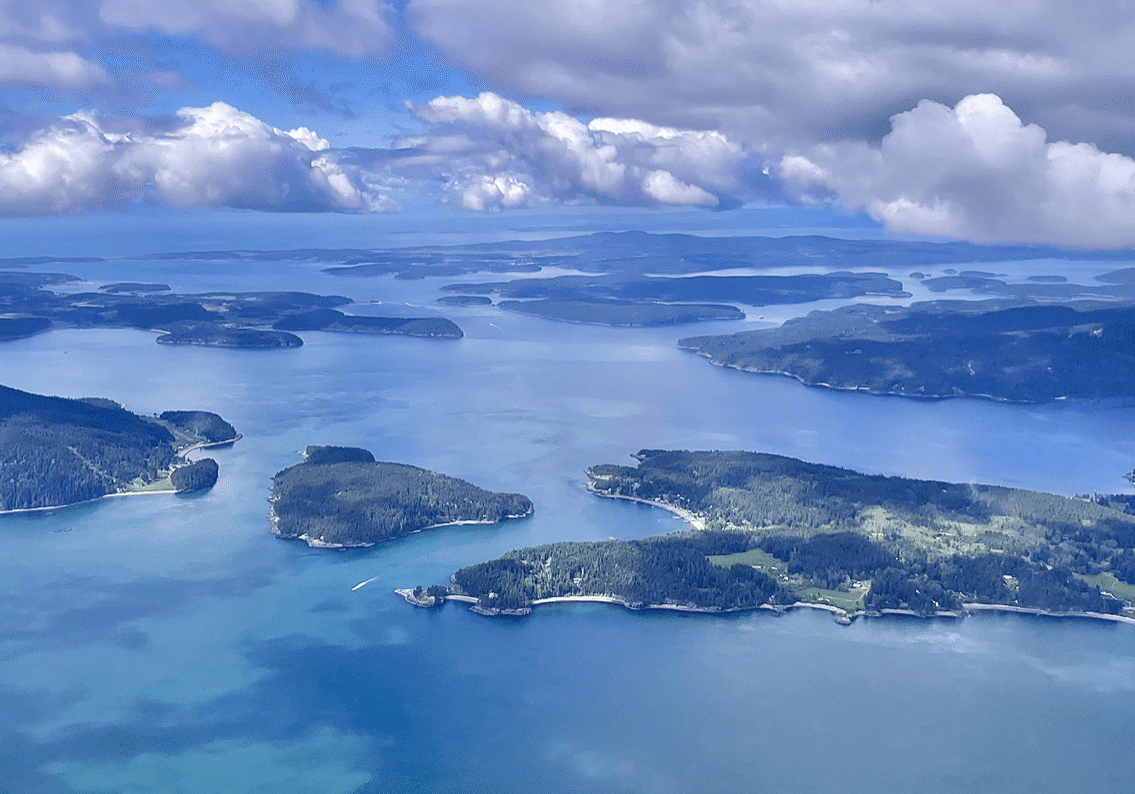 Aerial view of islands with cloudy sky.